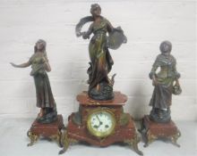 A three piece French spelter Louis Moreau clock garniture with pendulum and key (3)