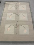 A hand-knotted rug with floral design on three-tone ground,