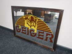A framed 1970's Geiger advertising mirror