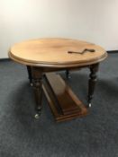 A circular Victorian wind out dining table with three leaves