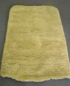 A hand knotted yellow/green rug,