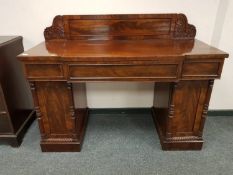 An early 19th century mahogany breakfronted pedestal sideboard,