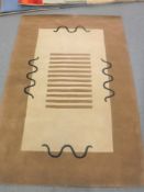 A hand-knotted rug on brown and beige ground,