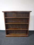 A set of stained pine open bookshelves
