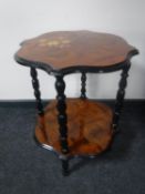 An Italianate style two tier occasional table in walnut finish