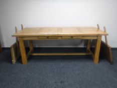 An oak refectory kitchen table with two extension leaves fitted with two drawers