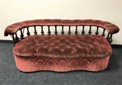 A late Victorian mahogany sofa upholstered in a pink buttoned brocade fabric