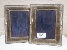 A pair of silver photograph frames, 14 cm x 17.5 cm.