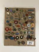Approximately seventy-five pin badges relating to tractors and motorcycles