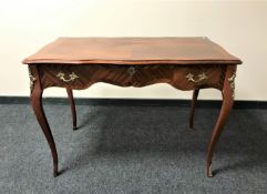 A reproduction Louis XV style writing table with gilt metal mounts