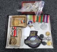 An interesting collection of WWII medals, commemorative medals, military buttons, badges etc.