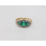 An 18ct gold diamond and emerald ring, size I CONDITION REPORT: 3.