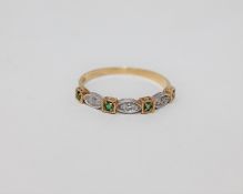 An 18ct gold emerald and diamond set half-eternity ring,