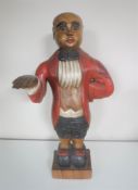 A wooden figure of a butler together with two vintage tennis rackets with stretchers