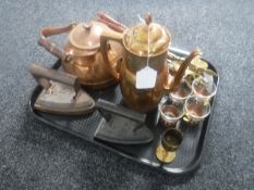 A tray of two antique flat irons, copper kettle and teapot,