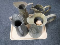 A tray of five copper and brass jugs