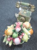 A brass and onyx telephone together with an Italian Capodimonte china fruit basket table ornament
