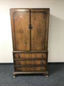 A walnut wardrobe fitted three drawers beneath