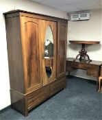 A Victorian inlaid mahogany triple door wardrobe together with matching four drawer dressing chest