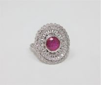 An 18ct white gold ruby and diamond ring, featuring one round cut natural ruby 1.