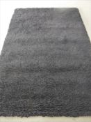 A hand knotted rug, shaggy black,