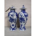 A pair of nineteenth century Chinese blue and white lidded urns, blue four character marks to base.