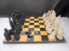 An onyx chess set with wooden board together with a further tile top chess set with oriental style