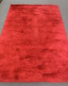 A hand-knotted shaggy rug in red,
