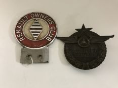 A Renault owner's club car badge together with a Russian Mercedes Benz car badge