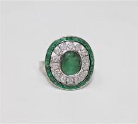 An 18ct white gold emerald and diamond ring featuring an oval cut emerald 2.