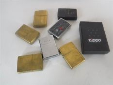 A box of eight assorted Zippo lighters