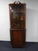An inlaid mahogany corner display cabinet together with an Italian style double door cabinet