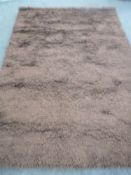 A hand knotted shaggy chocolate brown rug,