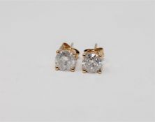 A pair of 14ct yellow gold diamond stud earrings, featuring two round brilliant cut diamonds 1.45ct.
