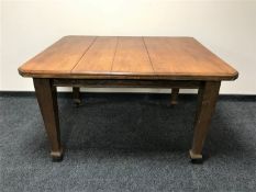 An Edwardian oak dining table
