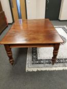 A Victorian mahogany extending dining table, with leaf,