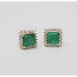 A pair of 14ct yellow gold emerald and diamond earrings featuring 1 square cut emeralds 3.