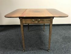 A Victorian mahogany flap sided table fitted a drawer