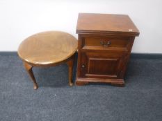 A bedside cabinet in a mahogany finish together with a circular oak coffee table