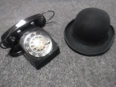 A vintage black telephone together with a bowler hat (with tags), size 6 7/8.