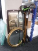 A bundle of walking sticks, shooting stick, circular gilt framed mirror, teak mirror,