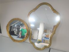 A gilt framed shaped mirror together with an oval gilt framed mirror