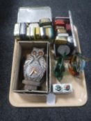 A tray of vintage tins, Pico wall clock in the form of an owl, cased servers, two glass fish,