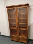 A continental mahogany glazed double door bookcase, width 90 cm.