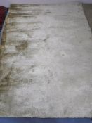 A hand knotted shaggy ivory rug,