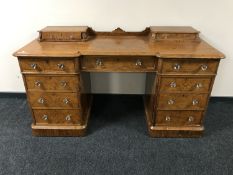 A Victorian pitch pine dressing table fitted eleven drawers with glass handles