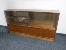 A set of mid 20th century teak sliding door bookshelves from the Herbert E.