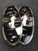 A pair of Japanese oval black lacquered mother of pearl panels depicting Geisha