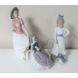 A Lladro figure of a lady in flowing dress (a/f) together with two Nao figures of a girl with a