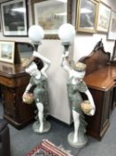 An impressive pair of carved marble figural floor lamps of maidens holding flowers, height 164cm